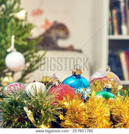 Christmas Balls And Tinsels Lying In A Box Near Chrictmas Tree