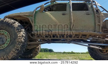 Money Pits 2.0 Off Road Truck Vehicle Truck Covered In Mud Being Towed Down The Highway In Summer, N