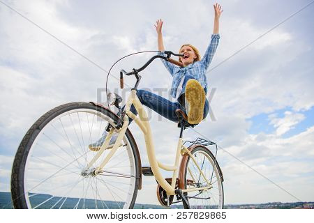 Girl Rides Bicycle Sky Background. Freedom And Delight. Woman Feels Free While Enjoy Cycling. Most S