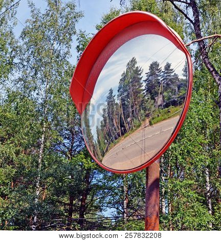 Security Mirror Thereflecting Twisting Highway In Rural Areas As  Metaphor Of Safety On The Road