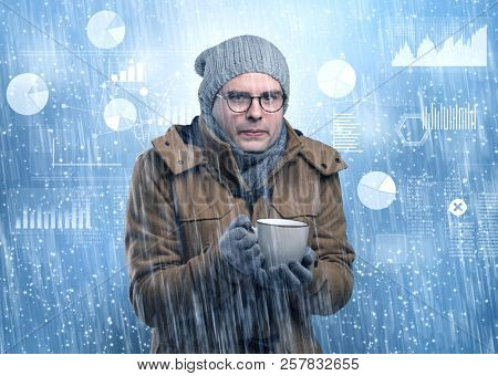 Young businessman shivering with graphs, reports and chart concept