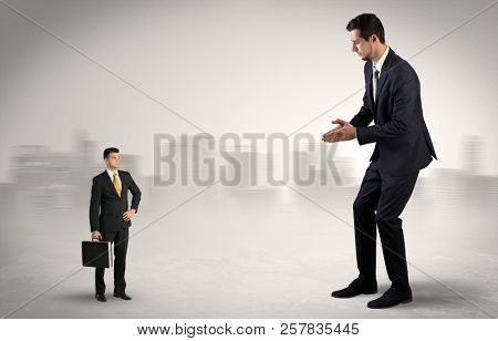 Giant businessman being afraid of small serious executor with suitcase