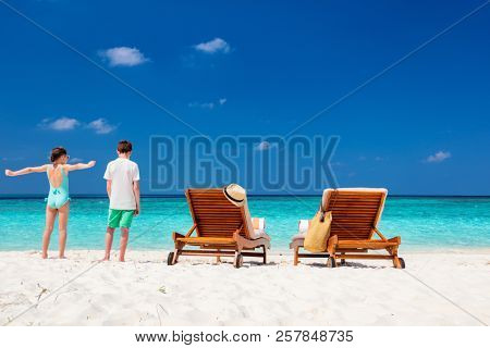 Kids brother and siter on a tropical beach during summer vacation