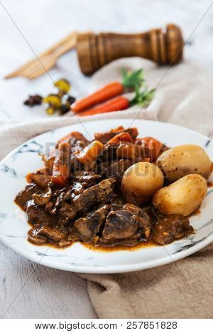 Beef meat stewed with potatoes-Traditional French cuisine Beef Bourguignon potatoes carrots in persillade