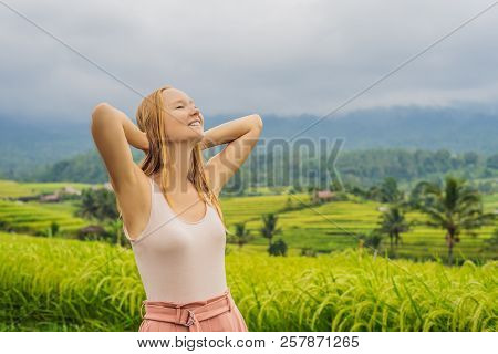 Young Woman Traveler On Beautiful Jatiluwih Rice Terraces Against The Background Of Famous Volcanoes