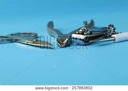 A View On Manicure Things As Scissors, Nail File, Special Scissors On Nails. Blue Background