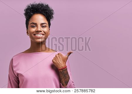 Horizontal Shot Of Beautiful Female With Dark Skin Keeps Mouth Opened, Wears Casual Lavender Clothes