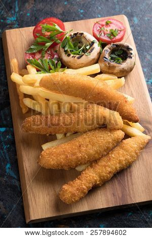 Deep fried chicken frites with potato chips or french fries
