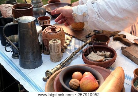 Still Life With Rural Repast Of Antique French Wooden And Metal Utensils, Vintage Scales And Simple 