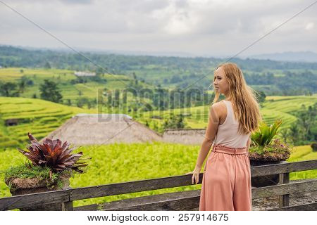 Young Woman Traveler On Beautiful Jatiluwih Rice Terraces Against The Background Of Famous Volcanoes