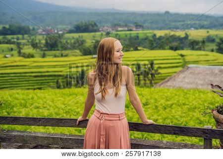 Young Woman Traveler On Beautiful Jatiluwih Rice Terraces Against The Background Of Famous Volcanoes