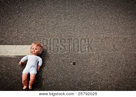 Doll Leave On A Highway Lane