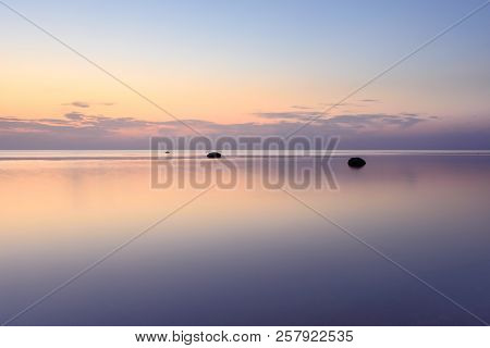 The Sky Is Reflected In The Sea At Sunset On A Long Exposure.