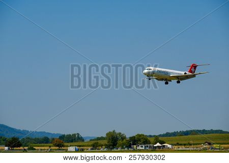 Zurich, Switzerland - July 19, 2018: Helvetic Swiss airlines airplane preparing for landing at day time in Zurich nternational airport