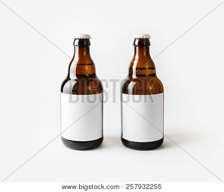 Two Brown Beer Bottles With Blank Labels.