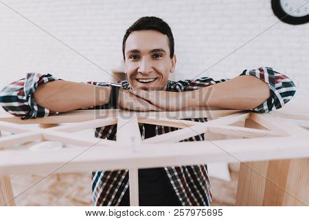 Young Man Assembling Wooden Bookshelf At Home. Wooden Bookcase. Selfmade Furniture. Man And Hobby. W