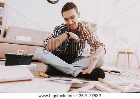 Young Man Assembling Wooden Bookshelf At Home. Wooden Bookcase. Selfmade Furniture. Man And Hobby. W