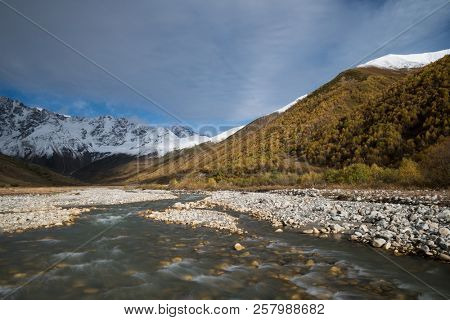Zemo Svaneti autumn. Enguri river and Shhara mountain, Georgia. Landscape with Main Caucasian ridge