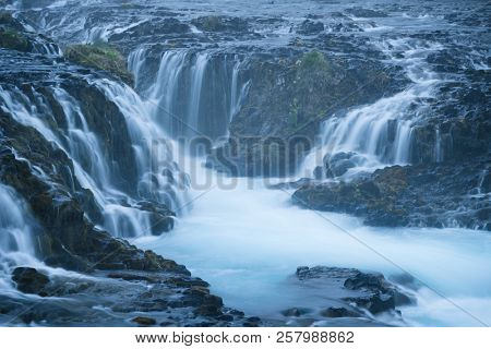 Waterfall cascades Bruarfoss, Iceland. The water is turquoise. Amazing in nature