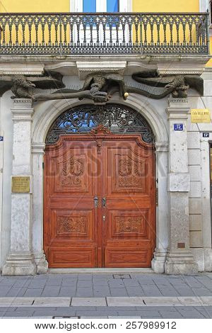 Trieste, Italy - May 18, 2010: Big Arch Doors With Snakes Entrance To House Of Bisse In Trieste, Ita