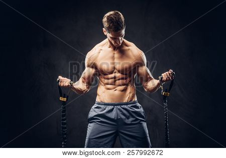 Handsome Shirtless Man With Stylish Hair And Muscular Ectomorph Doing The Exercises With An Expander