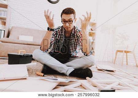 Young Man Assembling Wooden Bookshelf At Home. Wooden Bookcase. Selfmade Furniture. Man And Hobby. W