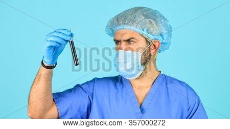 Epidemy Health Danger. Doctor In Respirator Mask. Nurse Look At Test Tube With Blood. Coronavirus Fr