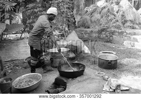 Man Cooking Food Over A Fire