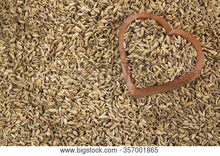 Fennel Seeds In A Heart-shaped Wooden Bowl - Foeniculum Vulgare