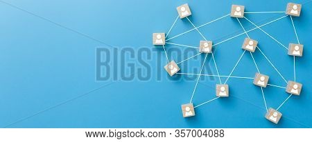 Wooden Blocks Connected Together On Blue Background. Teamwork, Network And Community Concept.