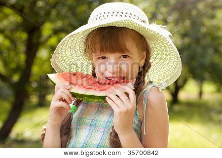 Girl In Hat Eating A Red Watermelon