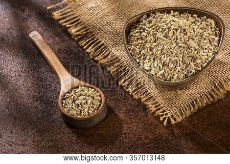 Dried Fennel Seeds In A Wooden Bowl With Wooden Spoon - Foeniculum Vulgare