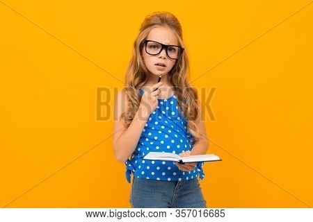 Portrait Of Young Caucaian Girl With Long Fair Hair In Black Glasses Thinks