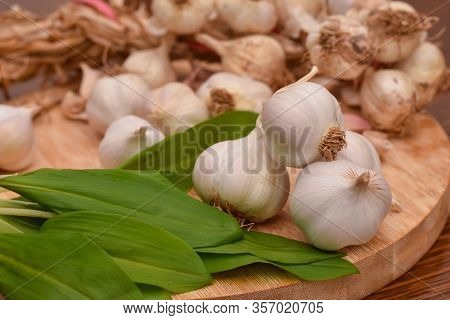 Wild Garlic Ramson Or Bear Garlic With Garlic Bulb And Garlic Cloves On Wooden Cutting Board