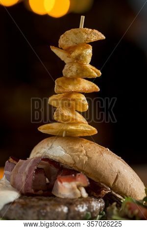 Burger Of Beef Meat With Melted Chedar Cheese, Bacon,tomato, Rocket Salad With Spicy Fries On The Ta