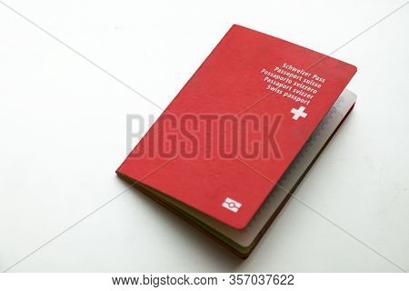 Close-up Red Swiss Citizen Passport At White Background