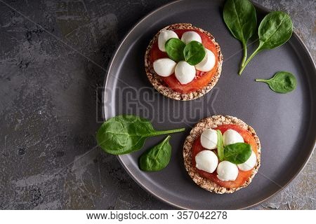 Toasts With Mozzarella, Tomatoes And Spinach In A Gray Plate