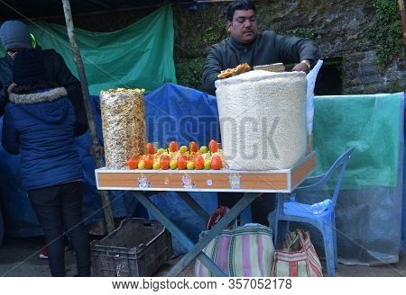 Darjeeling, India- December 27, 2019: Indian Man Selling Street Food Poha Or Onion Pohe Popular Trad