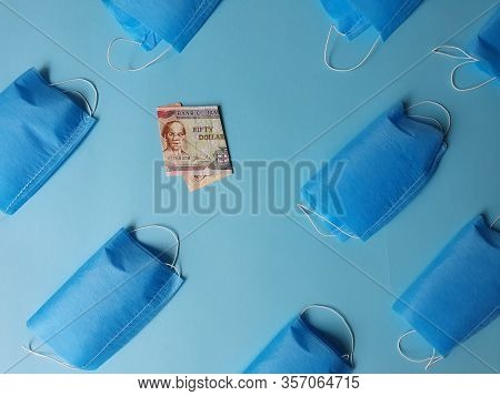 Jamaican Banknote Of Fifty Dollars And Masks On The Blue Background