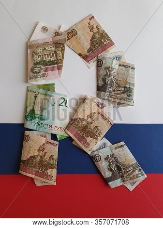Russian Banknotes Forming The Letter R On The Background In White, Blue And Red Colors