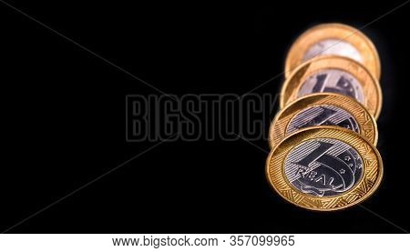 One Real Coins Isolated On Black Background. Money From Brazil. Brazil Economy Or Financial Crisis C
