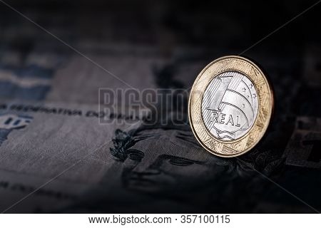 Image Of Money From Brazil, Banknotes Of 100 Reais And Coins, With Contrast And Shadows. Concept Of