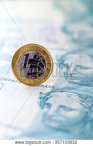 One Real Coin And Gold Bars. Concept Of Appreciation Of The Brazilian Currency In The Stock Market.