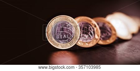 Images Of One Real Coins, Money From Brazil On Isolated Black Background. Falling Real Of The Brazil