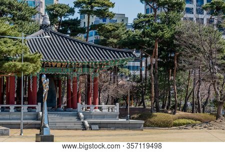 Daejeon, South Korea; March 16, 2020: Silver Sculpture Beside Ceremonial Bell In Oriental Pavilion I