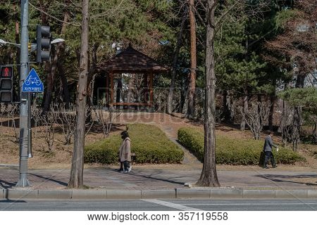 Daejeon, South Korea; March 16, 2020: Unidentified People Walking On Sidewalk In Front Of Picnic She