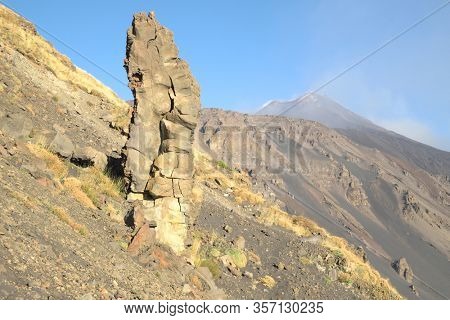 pinnacle of magmatic rock formation on steep slopes of Bove valley above active South-East Crater Of Etna Volcano, Sicily