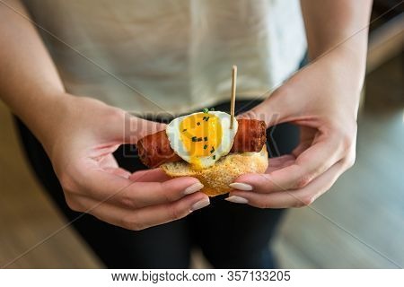 Close Up Photo Of A Tapa With Spanish Chistorra Sausage And Quail Egg.