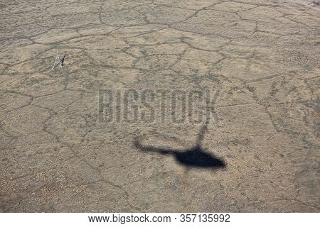 Helicopter shadow on tundra landscape in summer, Taymyr peninsula, aerial view
