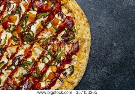 Pizza On A Dark Background. Classic Italian Pizza With Tomatoes, Pepper, Vegetables, Sauce And Mazar